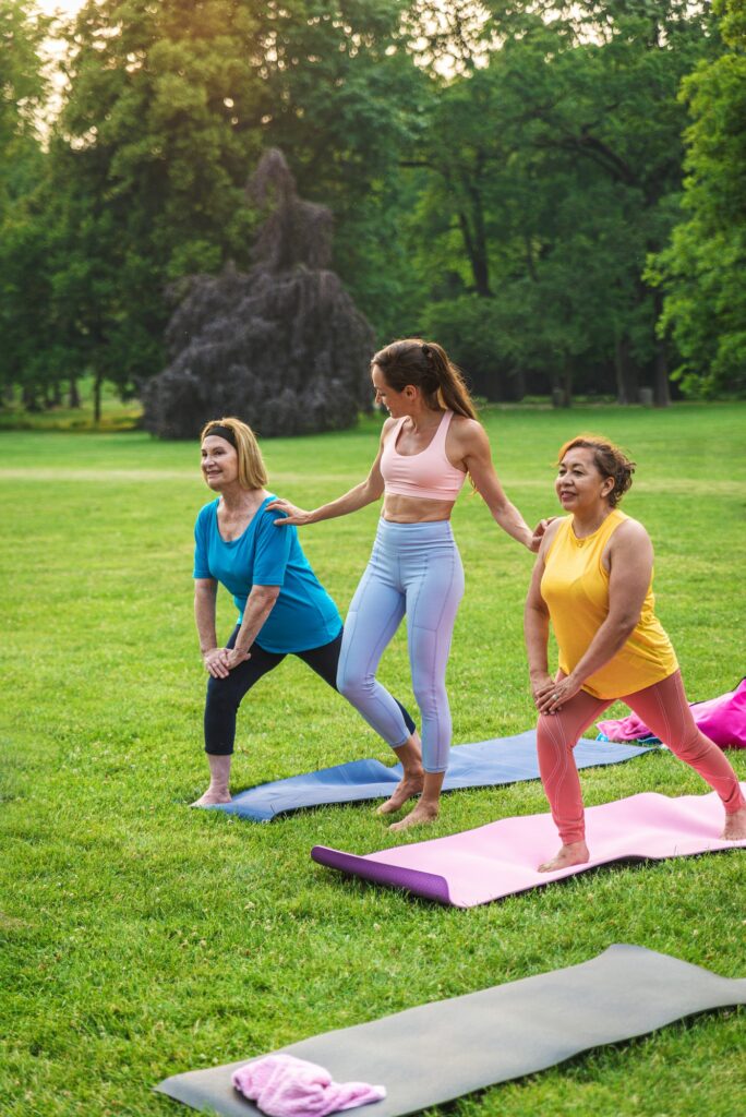 Senior women training with fitness coach at park